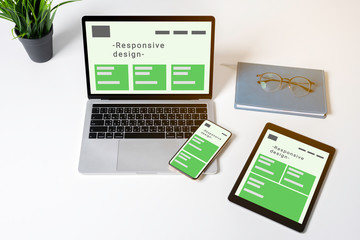 Responsive web design on laptop, tablet computer and mobile phone with clipping path from above.