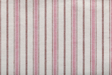 Colored striped coarse linen fabric texture closeup as background. Rustic canvas fabric texture.
