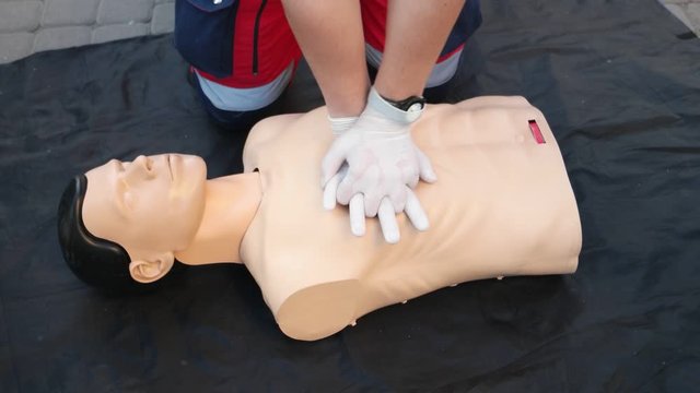 Medical specialist  is demonstrating a technique of a cardiopulmonary resuscitation on a medical training