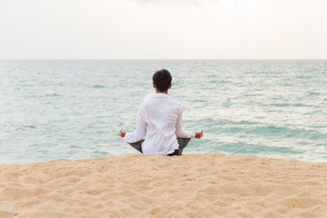 Fototapeta na wymiar Young man with Yoga and meditation on the beach