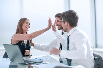 close up. happy employees showing their success