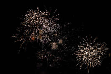 Fireworks in the sky. Salute exploded in a colorful ball in the night sky. Sparks and lights on a...