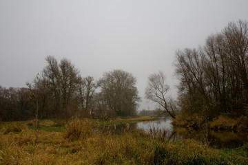 Polish autumn cold gray cloudy November landscape of Podlasie with the river Bug