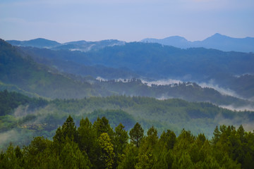 Beautiful landscape of green hills at sunrise. Buluh Payung Hill, Kebumen, Central Java, Indonesia