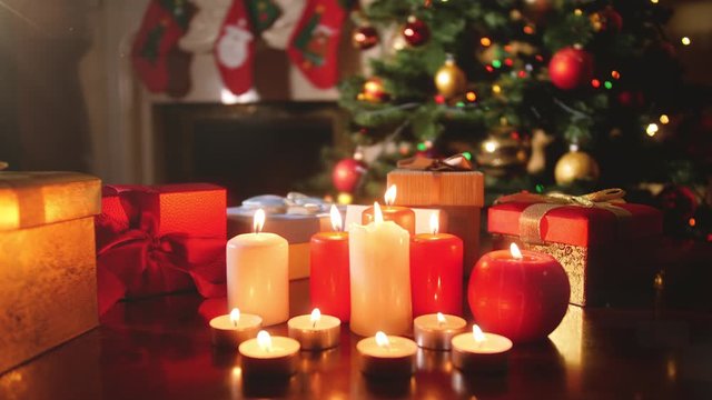 4k video of beautiful living room with fireplace and advent candles decorated for Christmas or New Year. Perfect background or backdrop for Christmas or New Year