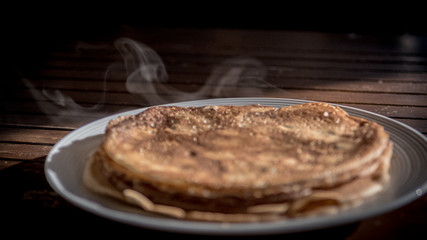 Isolated close up plate of fresh delicious steaming crepes 