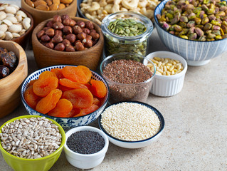 fresh nuts and dried fruis on granite surface