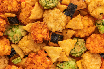 Background of Japanese rice and corn snacks with seaweed and wasabi