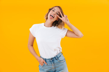 Image of funny blond woman in basic t-shirt showing peace fingers
