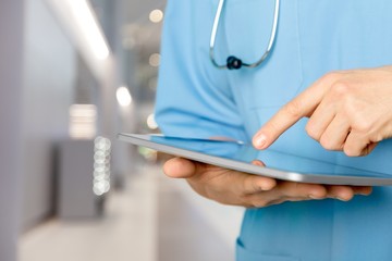 Doctor at hospital working with tablet pc
