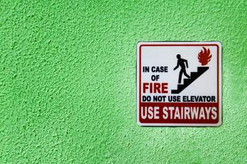 Warning sign on green wall with copy space