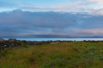 Fototapeta na wymiar A landscape around sunset of the Atlantic Coast, photographed near the Grotta Island Lighthouse, Reykjavik, Iceland.