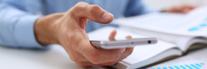 businessman holds a new smartphone in his hand