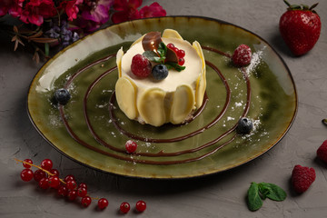 berry dessert with cream and almond petals