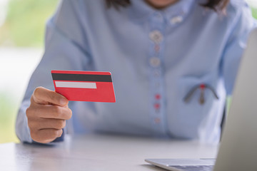 Woman hands holding credit card and using  laptop computer.Pays for purchase.Online shopping concept.