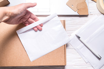 Hands puttinf Shipping Label to holder