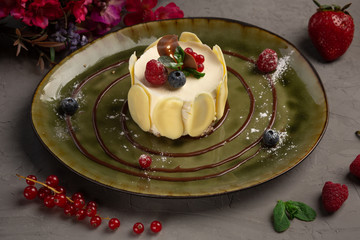 berry dessert with cream and almond petals