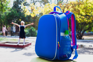 School bag and an elementary student on playground