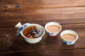 Ceylon tea in a teapot and mug closeup. Leafy beautiful tea copy space. Autumn, comfort, tea, warmth, concept.