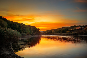 Lake surrounded by the forest in autumn sunset. Sumarice lake near the Kragujevac in Serbia.