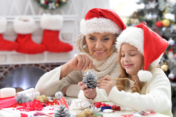 Fototapeta na wymiar Portrait of grandmother and child preparing for Christmas
