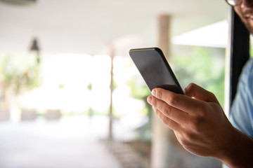 Male hand typing on mobile phone	