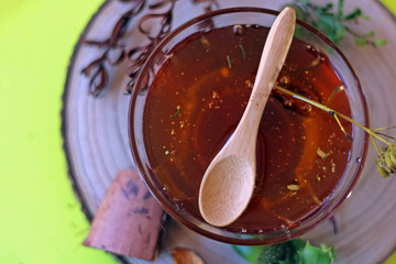 Natural Medicine concept: Jar with essential oil and a bamboo spoon.