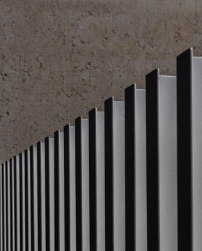 White painted steel bars align making a fence