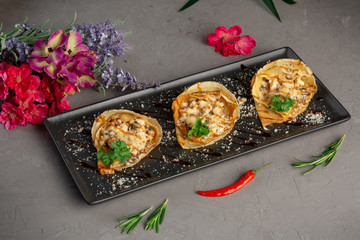 pancakes stuffed with julienne and decorated with greens