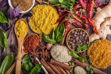 Heaps of various ground spices on wooden background. Georgian spices, Indian spices, Arabian spices. Spice variety. Herbs and spices