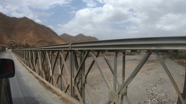 Car drive over the bridge on the road from Simien Mountain to Aksum. View from the car window. Ethiopia, Africa