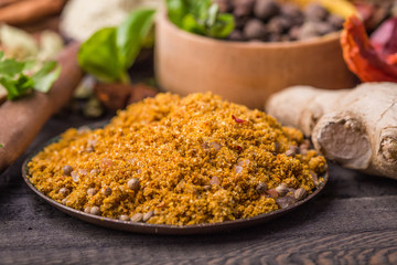 Heaps of various ground spices on wooden background. Georgian spices, Indian spices, Arabian spices. Spice variety. Herbs and spices