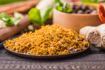 Heaps of various ground spices on wooden background. Georgian spices, Indian spices, Arabian spices. Spice variety. Herbs and spices