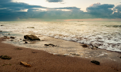 Sandy beach with stones in the early morning