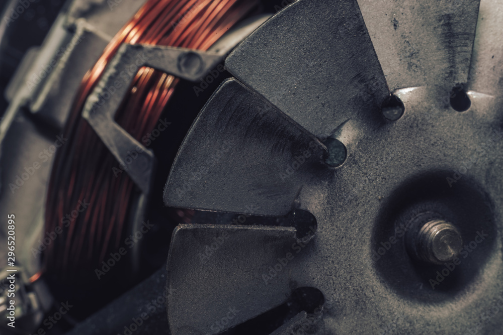 Poster close up old electric motor impeller on a dark background. macro view.
