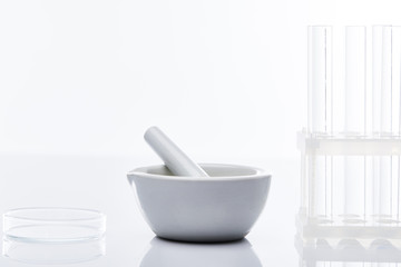 empty glass test tubes and mortar with pestle isolated on white