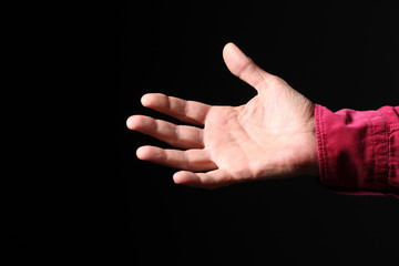 close up on a male open hand isolated on black background with copy space for your text