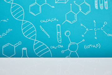 blue background with molecular structure signs near white surface