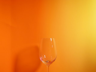 Wine glasses with orange background.
