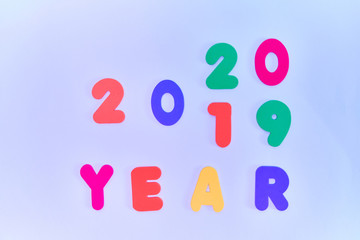 Text, 2019/2020, in multicolored letters on a blue background. Change of numbers in the new year
