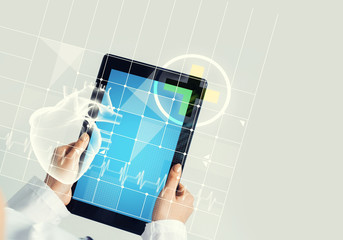 Close of female doctor hands working with tablet pc computer