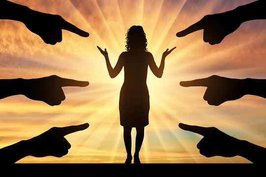 Silhouette of hands show at a woman standing on a sunset background