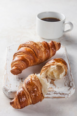 Breakfast. Croissants and coffee on the table