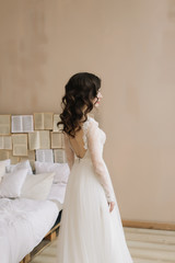 Fototapeta na wymiar Bride in lingerie. Morning wedding gatherings. tenderness concept. Elegant classic wedding dress. 