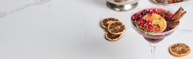 panoramic shot of christmas cocktails with orange, pomegranate, cinnamon