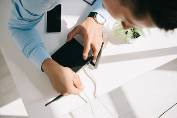 selective focus of businessman plugging router on office table