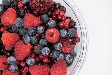 Various colourful berries in glass blow on white background, strawberry, raspberry, blackberry, blueberry, healthy food concept.