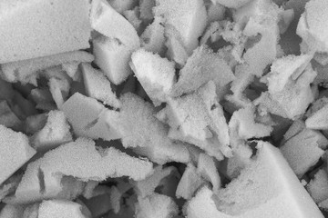 white polyurethane foam rubber pieces background texture. stuffing for pillows and furniture