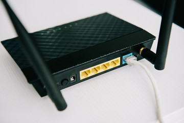selective focus of black plugged router on white table