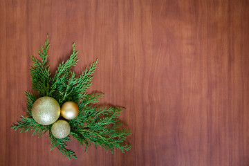 Christmas wooden background with fir branches and balls. New Year's decoration.